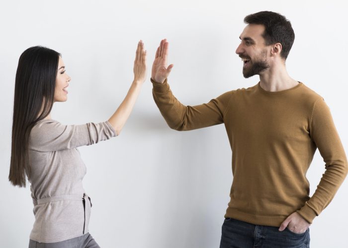 happy-young-man-woman-high-five-together happy-young-man-woman-high-five-together